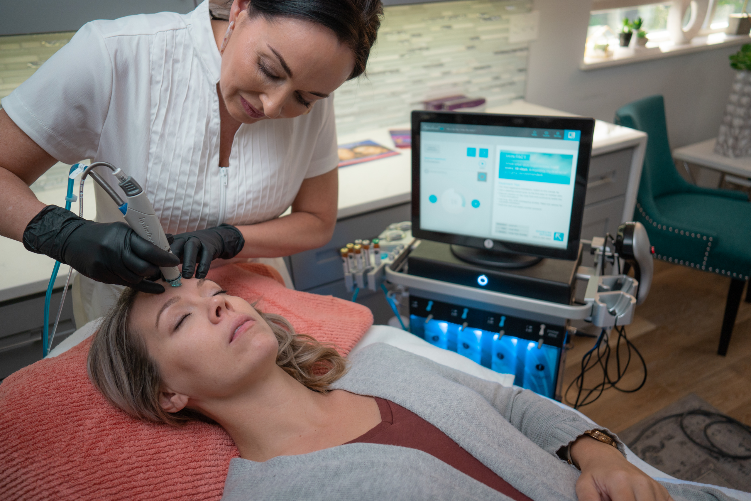 woman lying on her back receiving a botox facial treatment